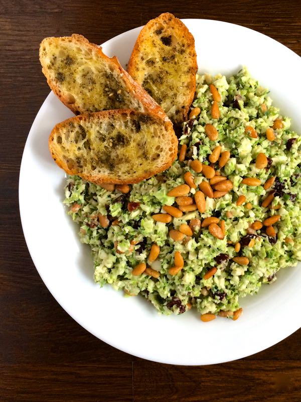 Creamy Tahini Brussels Slaw with Dried Cherries Toasted Pine Nuts and Zaatar Croutons