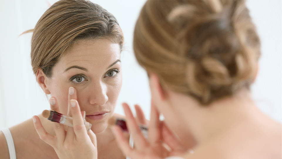 Applying concealer under eyes Adobe