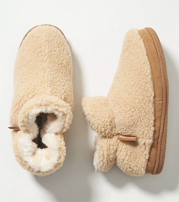 A pair of mini booties lined with beige bouclé fabric