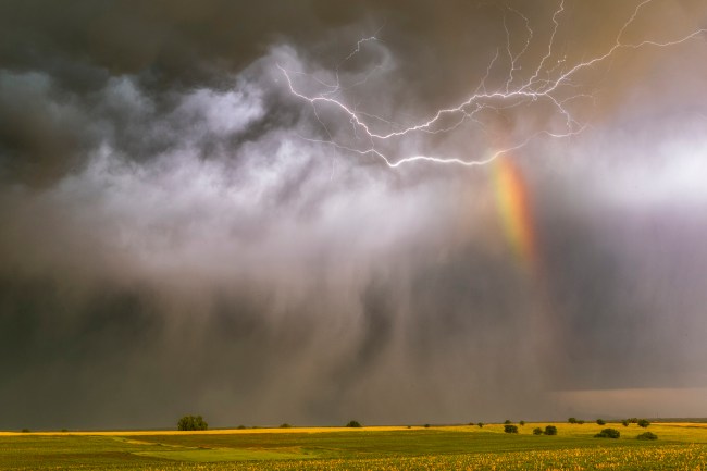Extreme weather with Lightning lighting up falling hail and a rainbow at sunset, taken south of the town of Superior, Nebraska, tornado alley USA.