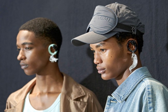 Two models wearing dangling earrings