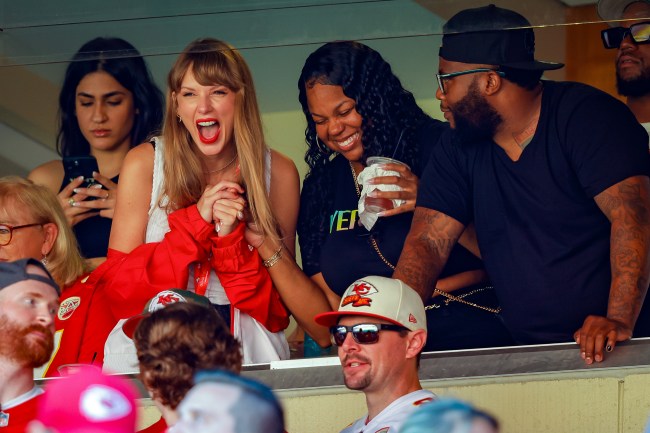 Taylor Swift, in a white top and red jacket, cheers on the Chiefs in a game against the Chicago Bears
