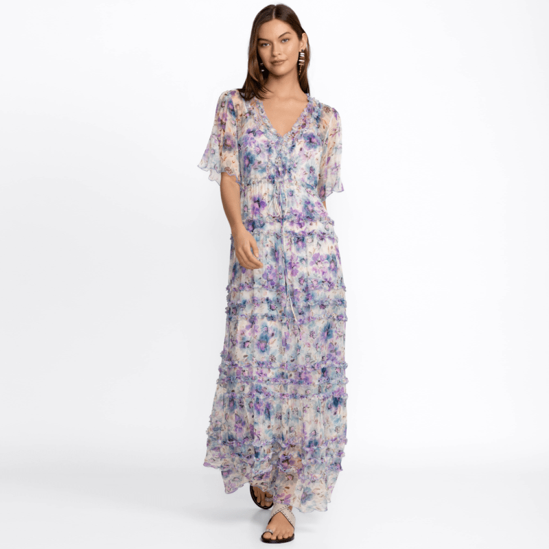 A model wearing a short-sleeve, floral, semi-sheer maxi dress