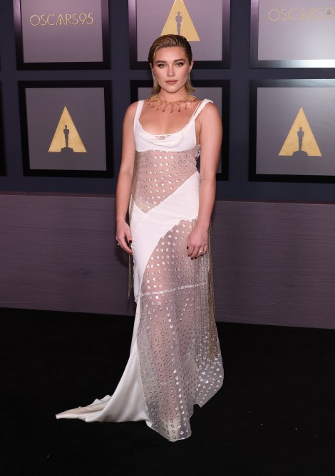 Florence Pugh in a whit evening gown with large see-through panels at the Academy of Motion Picture Arts and Sciences 13th Governors Awards red carpet