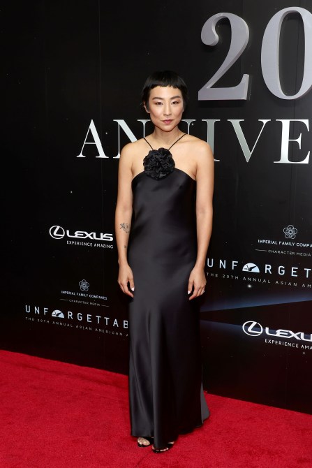 Greta Lee in a black halter rosette dress at the 20th Annual Asian American Awards Presented by Character Media red carpet