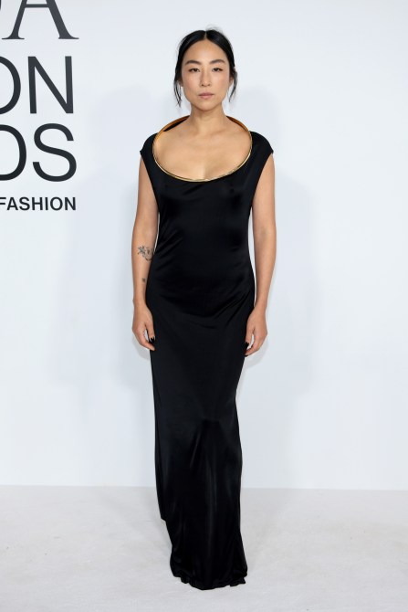 Greta Lee in a black evening gown with a dramatic round neckline at the CFDA Fashion Awards