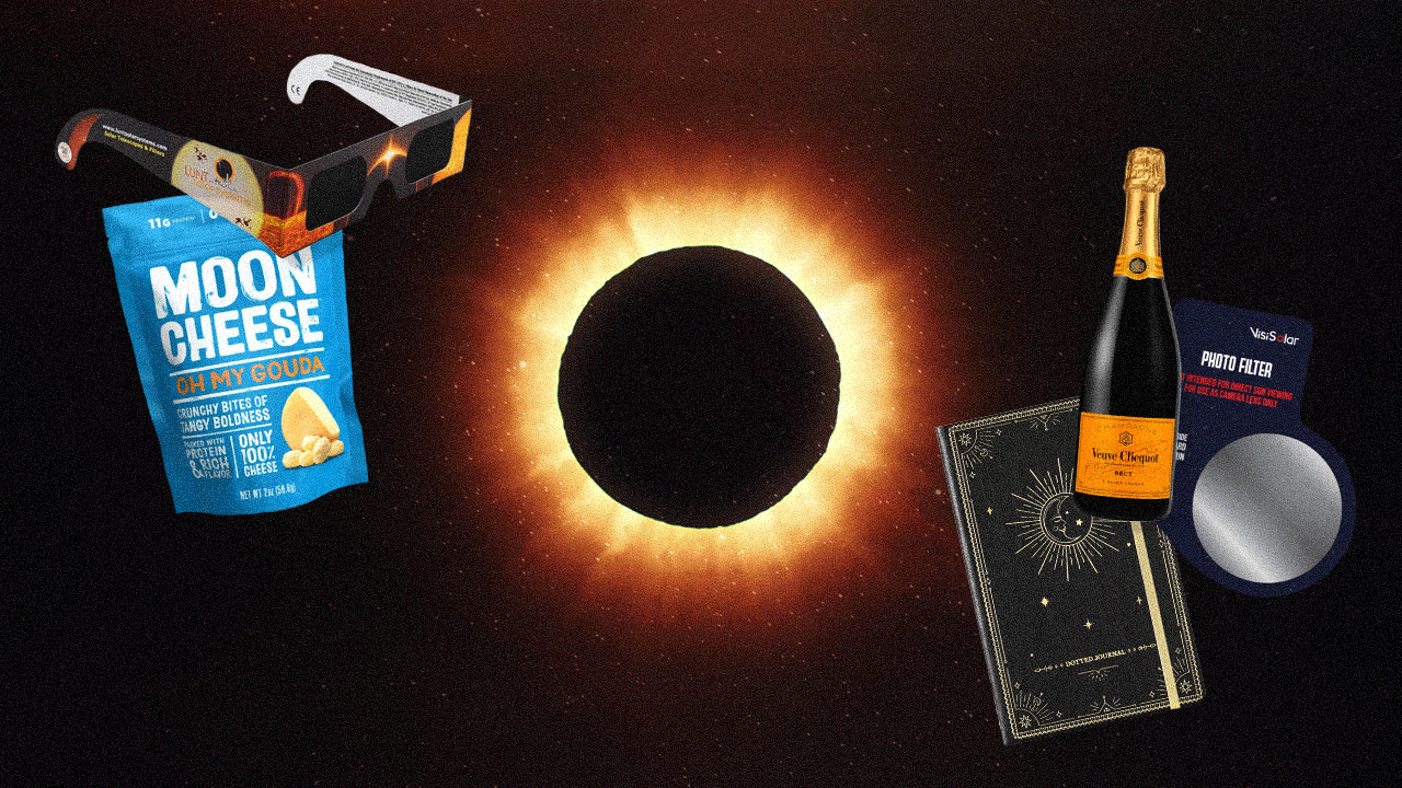 Solar eclipse essentials—like solar eclipse glasses, snacks, Champagne, and a journal—next to a total solar eclipse