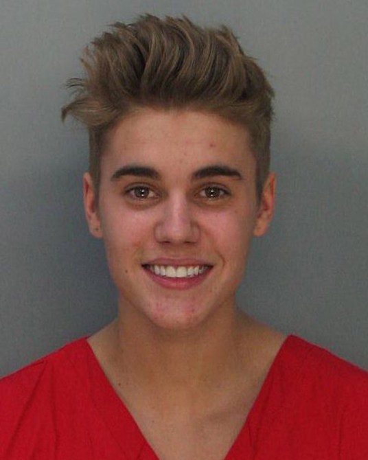 In this handout photo provided by Miami-Dade Police Department, pop star Justin Bieber poses for a booking photo at the Miami-Dade Police Department on January 23, 2014 in Miami, Florida. Justin Bieber was charged with drunken driving, resisting arrest and driving without a valid license after Miami Beach Police found the pop star street racing on Thursday morning.