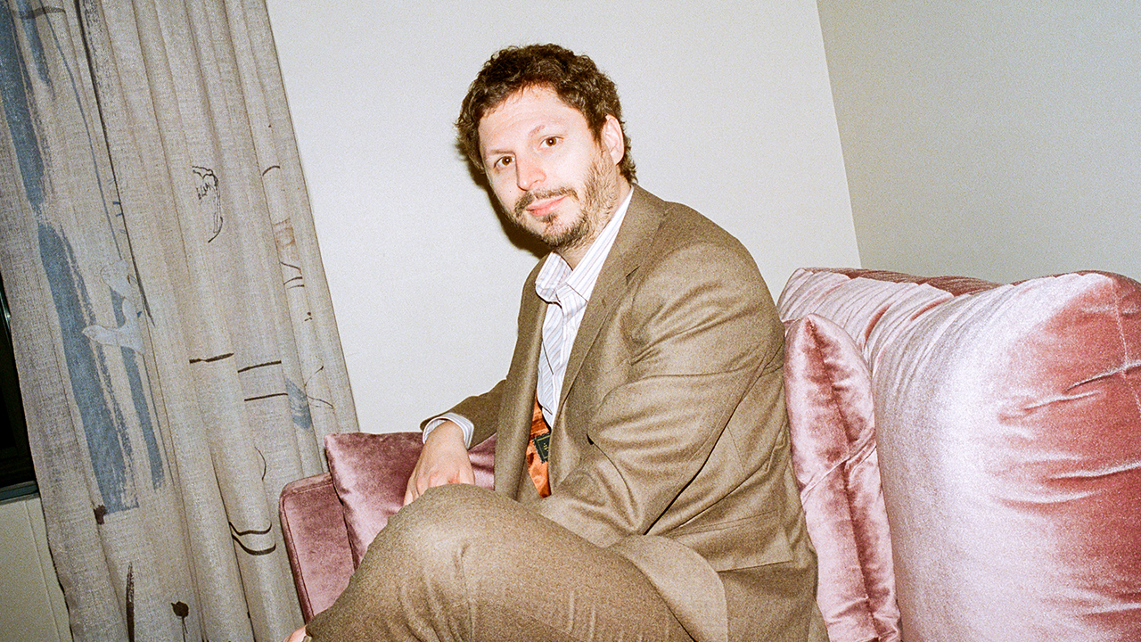 Michael Cera wearing a tan suit.