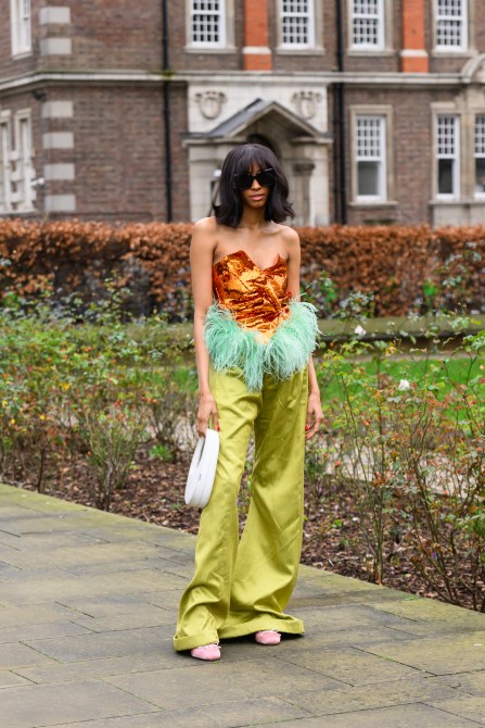 Woman wears YSL sunglasses, Coperni bag, Annie's Ibiza top, R. Michel’le the Label trousers, and Miu Miu shoes during London Fashion Week