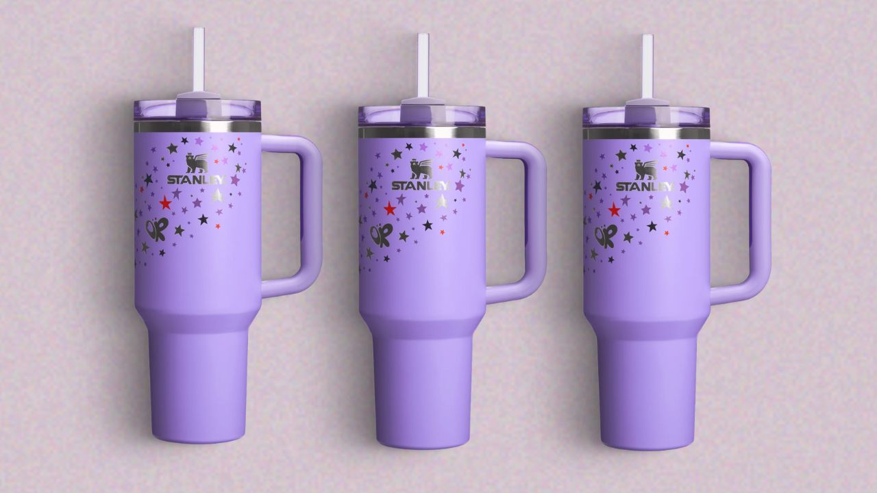 Three purple Stanley Tumblers on a lavender background