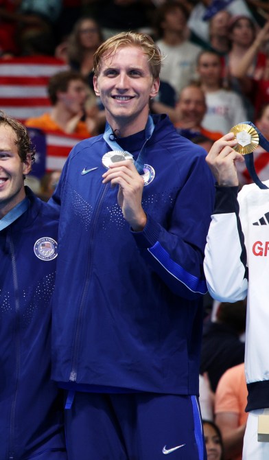 Silver Medalists Luke Hobson, Carson Foster, Drew Kibler and Kieran Smith of Team United States pose on the podium during the Swimming medal ceremony after the Men's 4x200m Freestyle Relay Final on day four of the Olympic Games Paris 2024 at Paris La Defense Arena on July 30, 2024 in Nanterre, France.