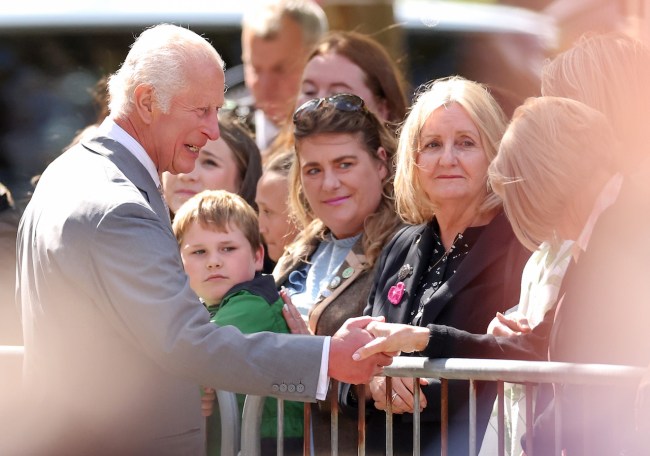 King Charles III shakes hands with a wellwisher as he departs Southport Town Hall after meeting members of the community and emergency services on August 20, 2024 in Southport, England. His Majesty met with those affected by the 29th July attack and riots alongside thanking frontline emergency staff for their ongoing work.