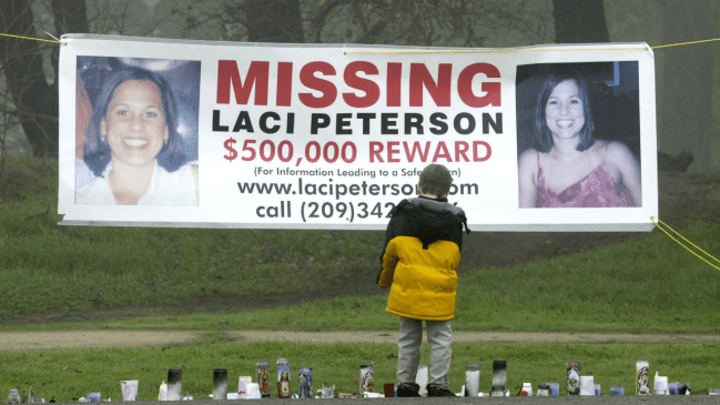 A young child stops to look at a makeshift memorial and a missing person's banner offering a half-million dollar reward for the safe return of Laci Peterson at the East La Loma Park January 4, 2003 in Modesto, California.