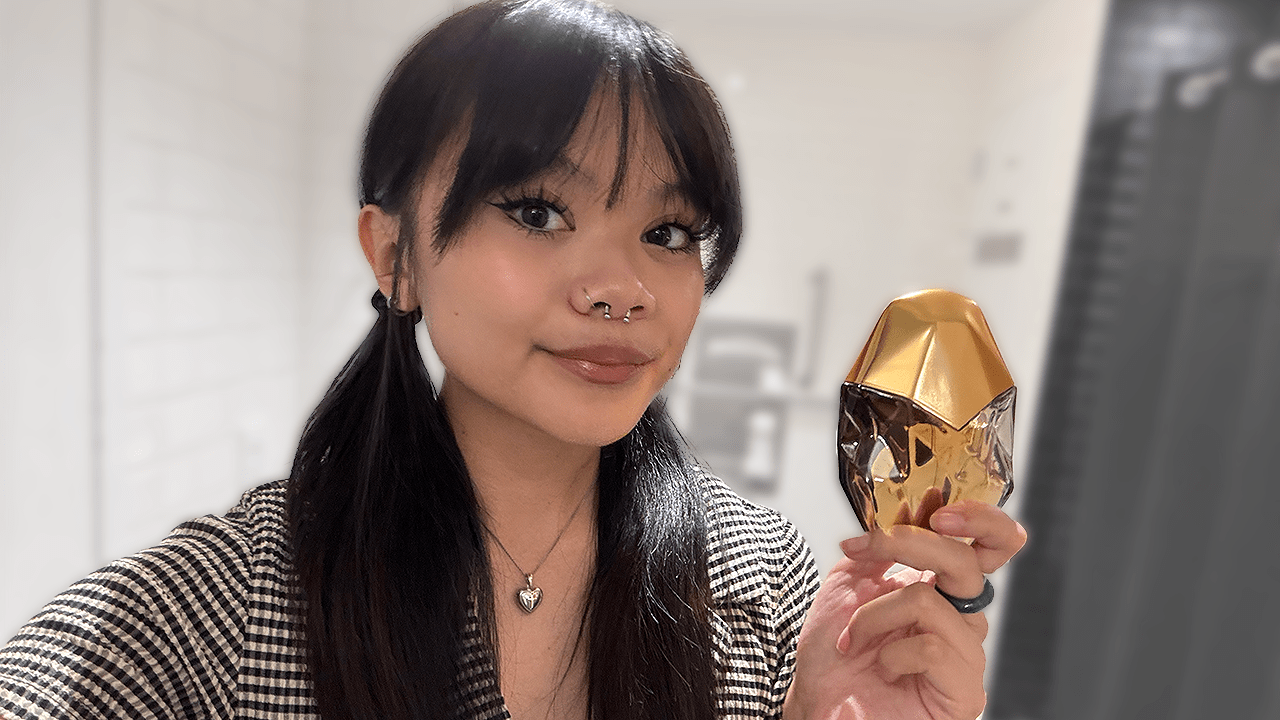 Kleigh Balugo holding the Orebella Nightcap Perfume.