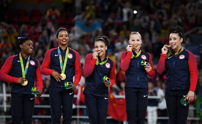 Gold Medalists Simone Biles, Gabrielle Douglas, Lauren Hernandez, Madison Kocian and Alexandra Raisman of the United States pose for phorographs on the podium at the medal ceremony for the Artistic Gymnastics Women's Team on Day 4 of the Rio 2016 Olympic Games at the Rio Olympic Arena on August 9, 2016 in Rio de Janeiro, Brazil.