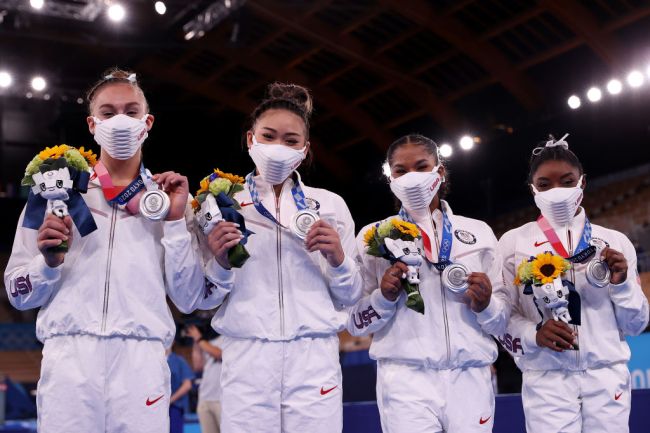 Grace McCallum, Sunisa Lee, Jordan Chiles and Simone Biles of Team United States celebrate after winning the silver medal during the Women's Team Final on day four of the Tokyo 2020 Olympic Games at Ariake Gymnastics Centre on July 27, 2021 in Tokyo, Japan.