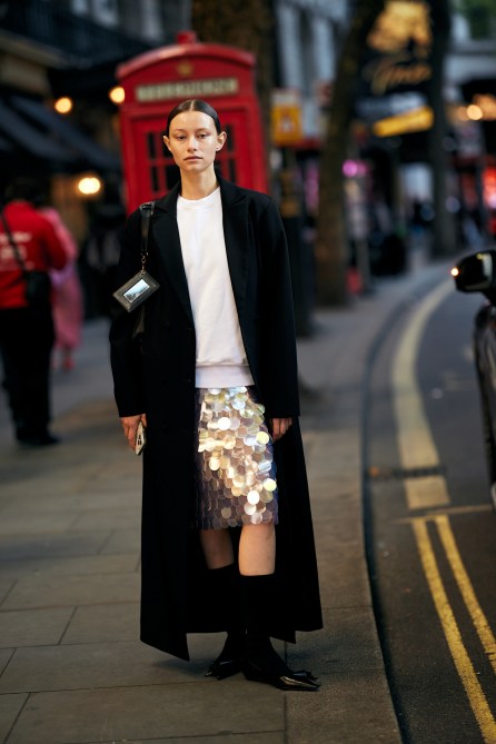 A fashion week guest wearing a sequin skirt.
