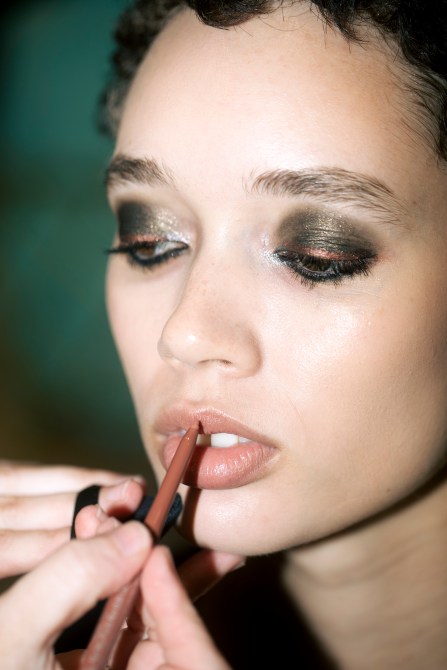 A model getting makeup done at Christian Siriano.