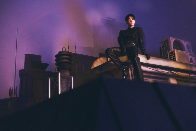 Baekhyun sitting on top a building