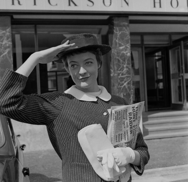 Actress Maggie Smith posing with her hand on her hat, 27th August 1957.