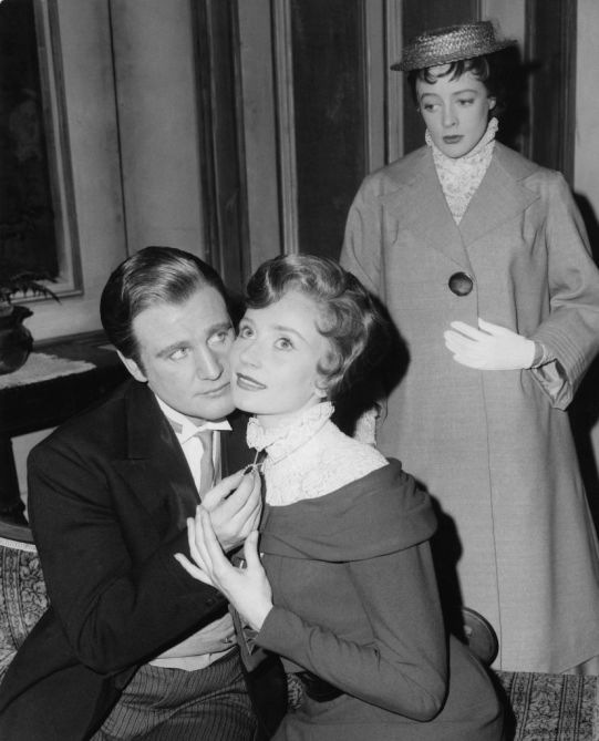 From left to right, actors Donald Houston (1923 - 1991) as John Shand, Wendy Williams as Lady Sybil Lazenby and Maggie Smith as Maggie Wylie during a dress rehearsal for the play 'What Every Woman Knows' by J. M. Barrie at the Old Vic in London, 11th April 1960. Here Maggie finds her husband John in the arms of Lady Sybil.