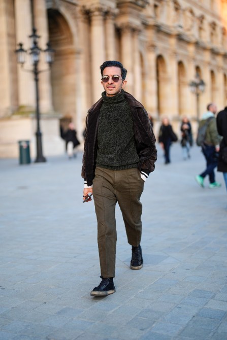 Imran Amed wears brown sunglasses, brown velvet jacket, dark green turtleneck, khaki pants, black sneakers shoes, outside Louis Vuitton, during the Paris Fashion Week Spring/Summer 2025 on October 1, 2024 in Paris, France.