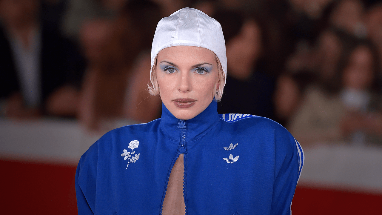 Julia Fox wearing a blue Willy Chavarria Adidas track jacket.