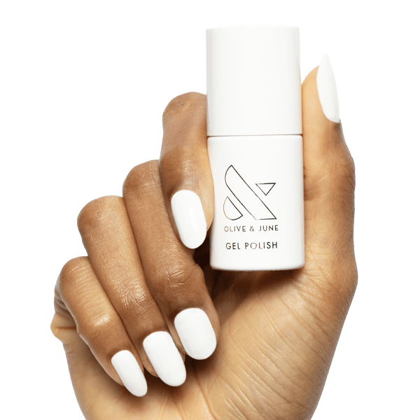 A hand model wearing and holding the Olive & June Gel Polish in HD