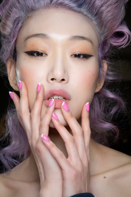 A model with pink French tip nails.