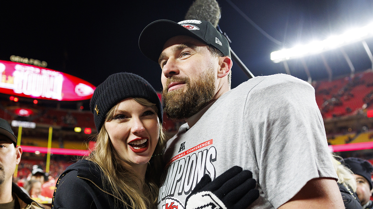 KANSAS CITY, MISSOURI - JANUARY 26: Tight end Travis Kelce #87 of the Kansas City Chiefs celebrates with Taylor Swift after the AFC Championship football game against the Buffalo Bills, at GEHA Field at Arrowhead Stadium on January 26, 2025 in Kansas City, Missouri