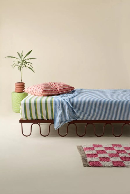 A bed on a brown, squiggly bed frame