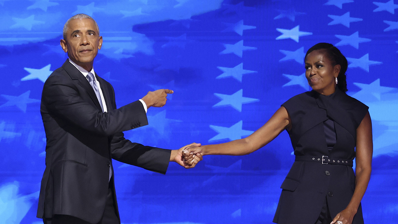 Former President Barack Obama and former first lady Michelle Obama embrace on stage Tuesday, Aug. 20, 2024, during the Democratic National Convention at the United Center.
