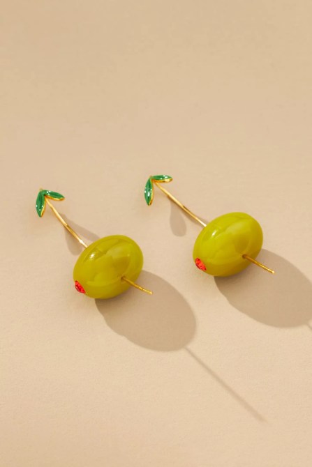 Two earrings that resemble green olives