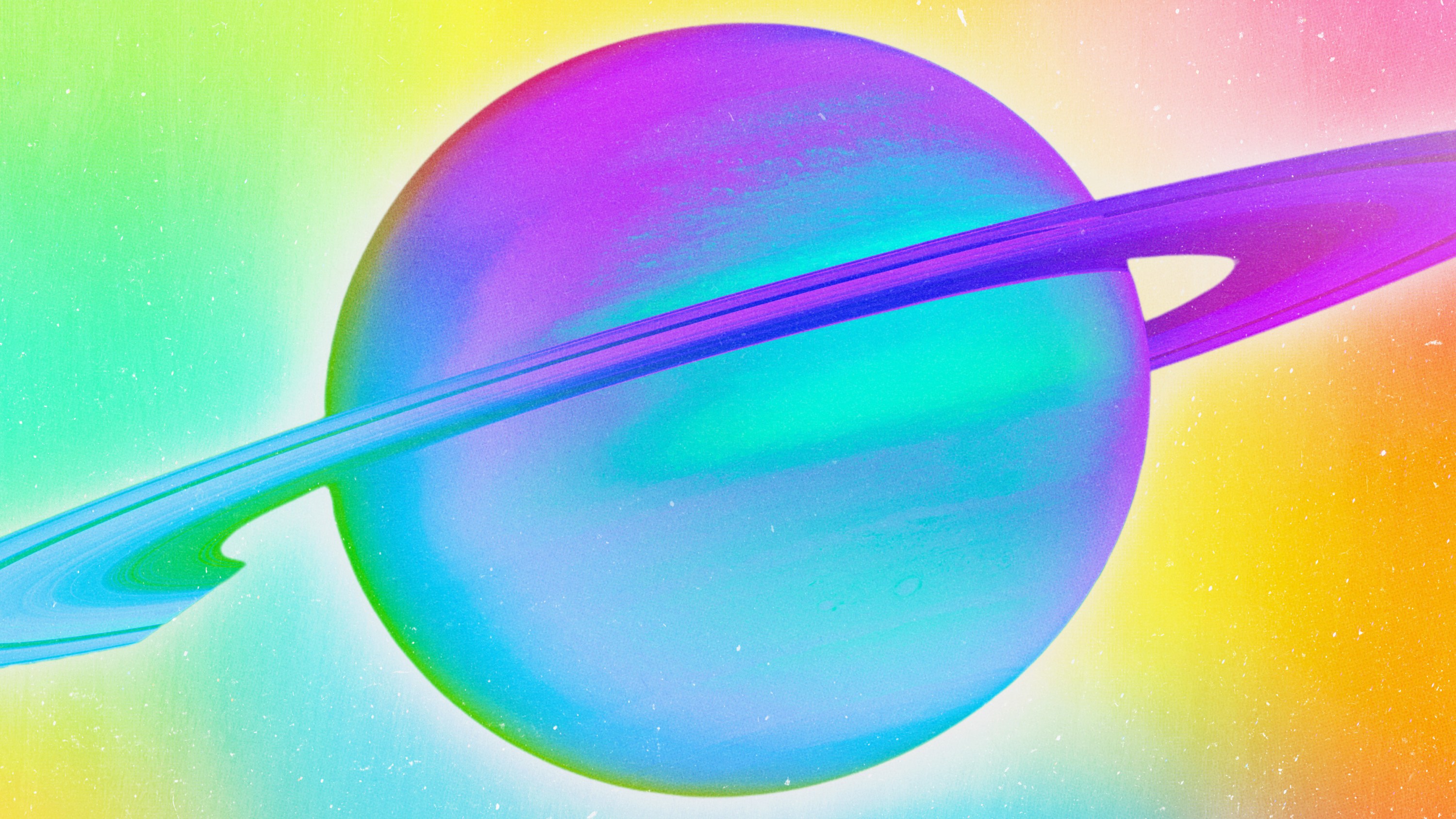 Planet Saturn displayed in rainbow prismatic colors.