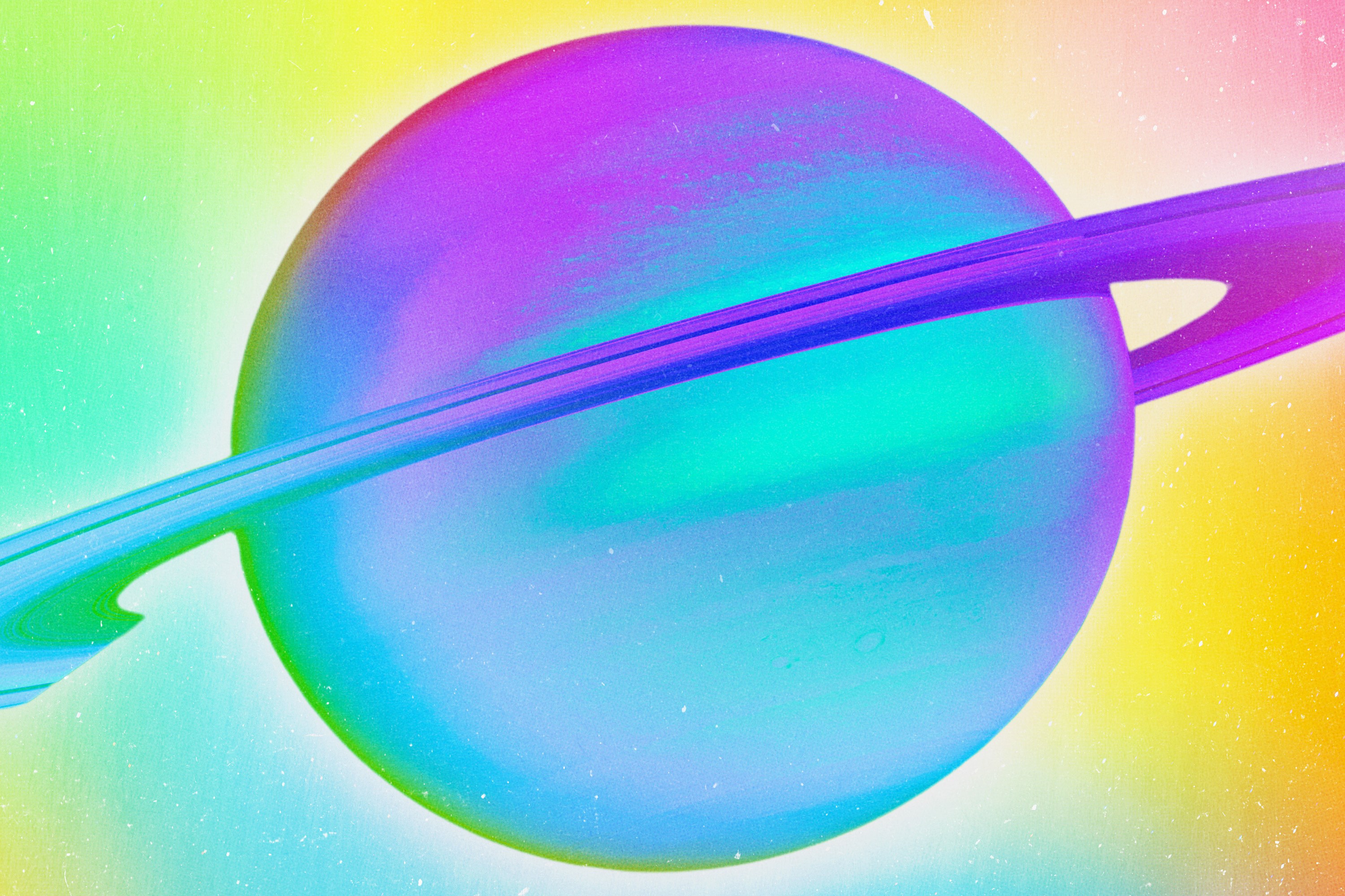 Planet Saturn displayed in rainbow prismatic colors.