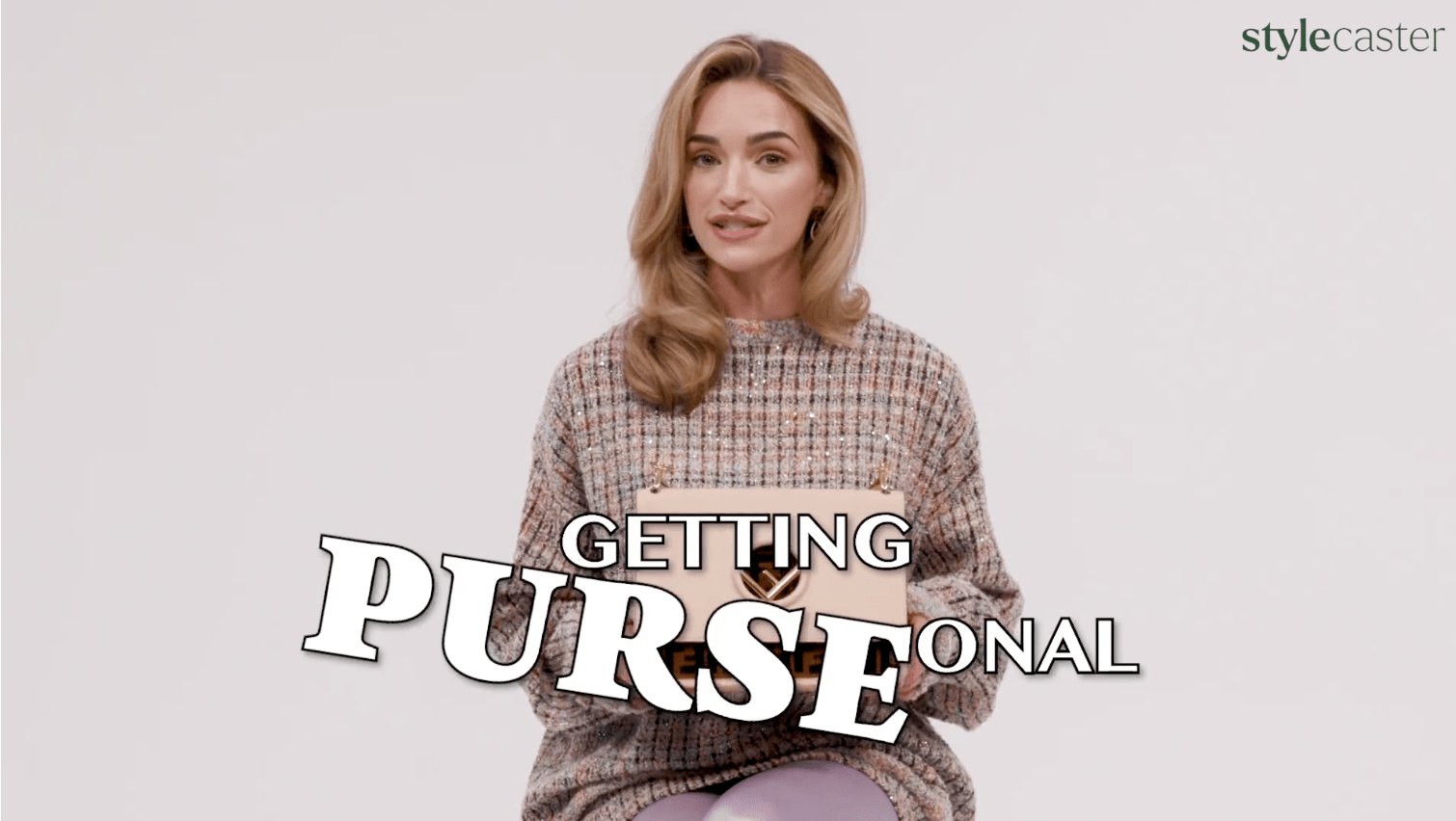 Brianne Howey holding a bag.